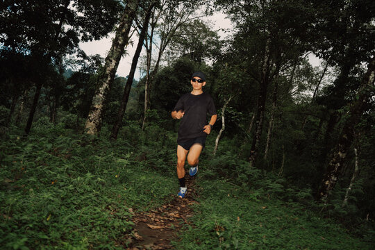 Running on a Trail in the Forest During Daytime Near Trees
