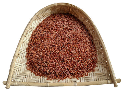 Traditional Sri Lankan Kulla winnowing fan, woven bamboo with red rice grains, handmade agricultural tool. Isolated on a transparent background