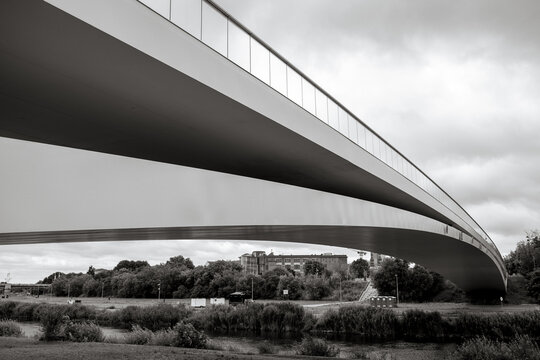 Poznan, Poland - July 8, 2026: The modern Berdychowskie Bridge forms sweeping lines above the Warta River floodplain.