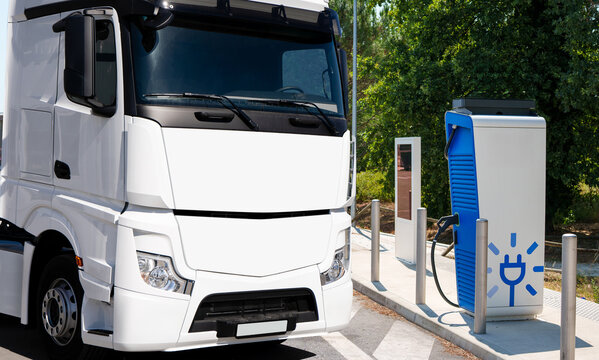 Electric truck next to EV charging station