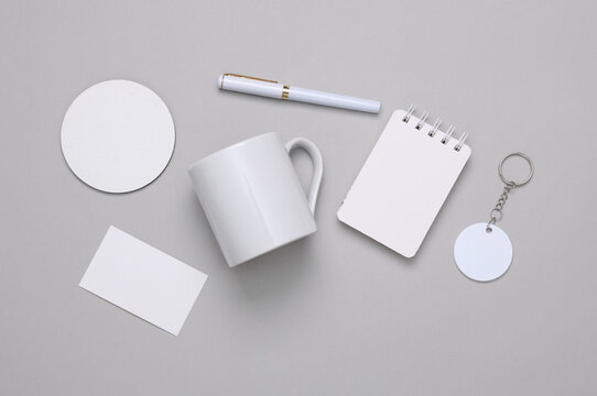 Corporate identity, set of white blank promotional products for business on a gray background. Flat lay. Creative mockup for your brand design.