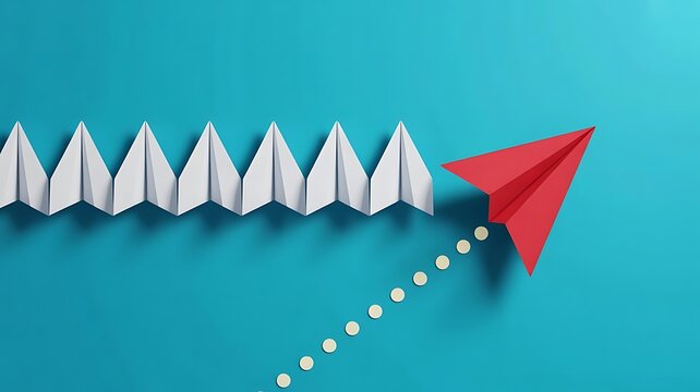 Red paper airplane flying upwards away from a row of white paper airplanes, concept of leadership, innovation, and standing out from the crowd