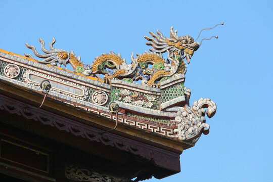 Traditional imperial dragon scale pattern on mosaic gable ornamentation, decorative eaves trim of ancient pagoda roof ridge with glazed pottery