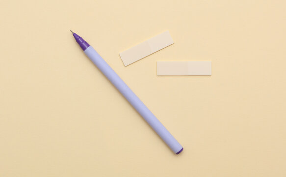 Paper stickers and pen on pastel background. Business concept.