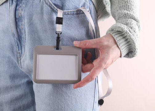 Blank Id card badge in front pocket of blue jeans on woman