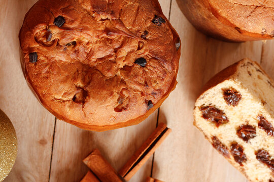 Artisanal Christmas panettone on a rustic wooden table, in a composition created for a festive celebration.