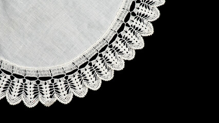 Round crochet lace doily isolated on black background, crocheted Grandma's Doily, detail of...