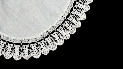 Round crochet lace doily isolated on black background, crocheted Grandma's Doily, detail of hand-crocheted embroidery, tablecloth, napkin border art design. Craft, vintage linen. Vintage table setting © Subbotina Anna