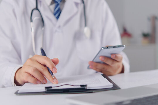 Doctor Using Smartphone and Clipboard for Mobile Healthcare Telemedicine Medical Communication Clinical Records and Digital Health Workflow