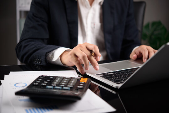 Business Finance Work on Laptop with Calculator and Reports for Budget Analysis Accounting Planning and Office Financial Management