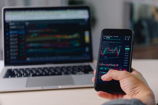 Stock Market Trading Analysis on Smartphone and Laptop with Price Charts for Investment Research Portfolio Monitoring and Online Finance