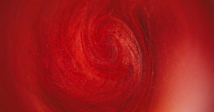 Defocused ink whirl. Color glitter. Red pigment bright water vivid rainbow vibrant fluid spreading on abstract acrylic art background.