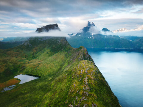 Norway nature aerial view Senja island foggy mountains and fjord landscape tranquil scenery, Arctic wild nature summer season travel destinations beautiful places in Scandinavia, view from Segla peak