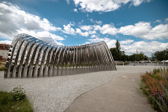 Wroclaw, Poland - July 10, 2026: Oskar Zieta&rsquo;s NAWA installation forms a sequence of mirror-polished stainless steel arches across landscaped Daliowa Island.