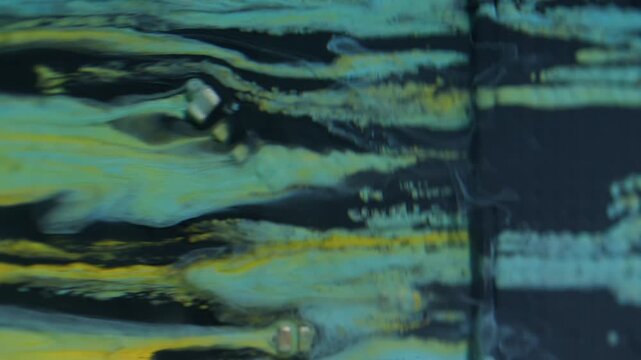 Processor detail. Paint stream. Blue yellow liquid spill on technological texture. Modern color abstract blur circuit art background.