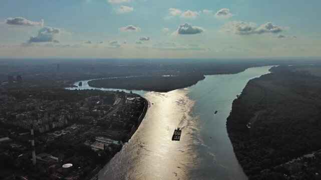 Aerial view of Belgrade at confluence of Sava and Danube rivers. Urban landscape, forested river island and city view, 4k
