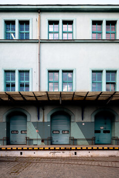 Wroclaw, Poland - July 10, 2026: Historic railway service building near Wroclaw Glowny forms an enclosed courtyard with rows of windows above a covered loading platform.