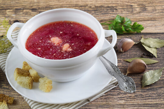 Borscht in a white, deep plate.