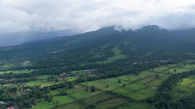 Aerial view showing the lush green landscape of La Fortuna and the Arenal Volcano National Park on a cloudy day in Costa Rica