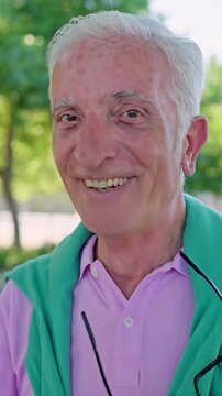 Portrait of a senior man putting off his eyeglasses and winking at the camera while smiling