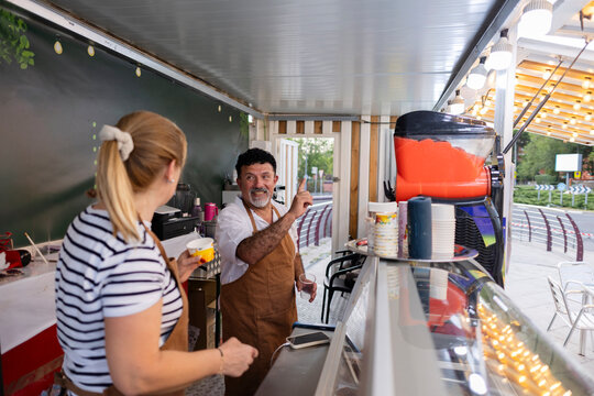 Food truck owners discussing business at street stand