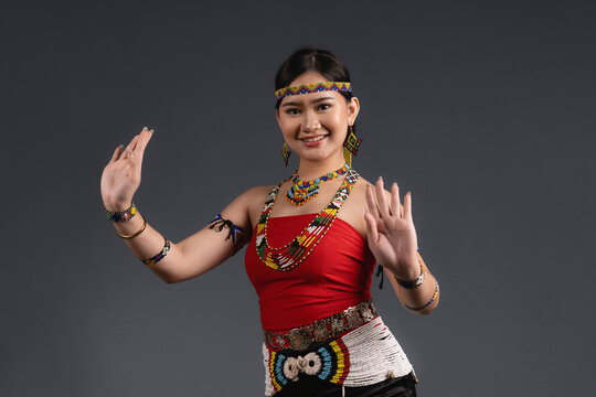 Smiling Sabahan Woman Wearing Traditional Murut Tahol Simba Costume Posing with Dance Gestures
