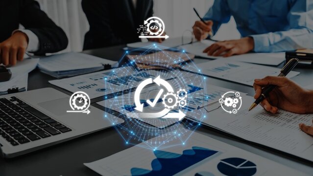A diverse business team collaborates at a modern office table, using digital technology and data analysis to optimize workflows and enhance project management strategies. Raster