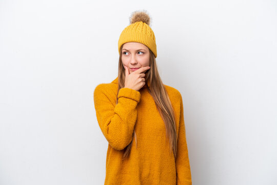 Young caucasian woman wearing winter jacket isolated on white background having doubts and with confuse face expression