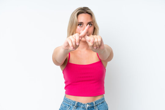 Young caucasian woman isolated on white background making stop gesture with her hand to stop an act