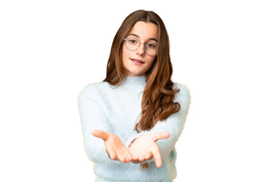 Teenager girl over isolated chroma key background holding copyspace imaginary on the palm to insert an ad