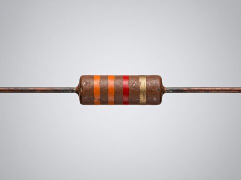Single copper lead resistor with orange orange red gold stripes for electronic assembly.