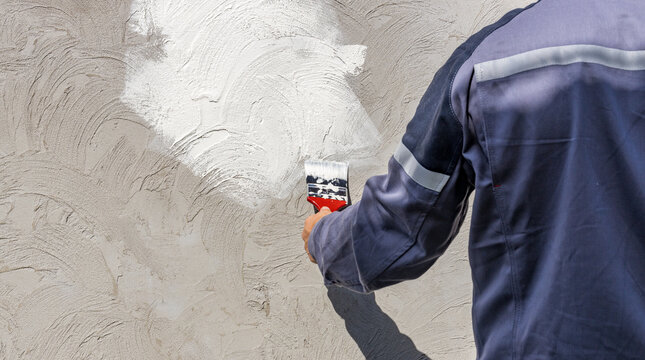 Painting concrete with spray can during repair work
