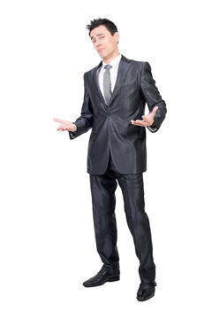 Full body of alluring man in formal suit looking at camera with palms up isolated on in studio