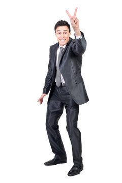 Full body of happy male in formal suit showing v sign and looking at camera with smile isolated on transparent background