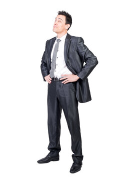 Full body of glad male in formal suit looking at camera with smile and hands on waist isolated on transparent background