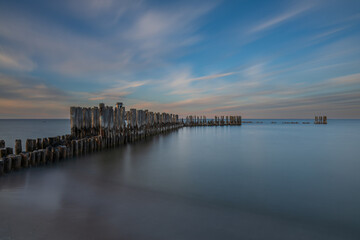 Fototapeta premium Sunset Long Exposure Of WWII Torpedownia Station And Breakwater In Baltic Sea