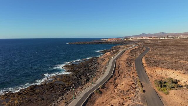 Aerial view of Caleta de Fuste, a resort town on Fuerteventura, one of Spain&rsquo;s Canary Islands, Spain. Drone POV exploration of the town architecture and the coastal lanshaft.