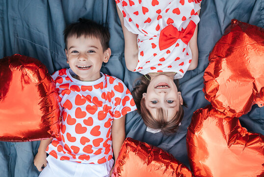 Children Play Together With Heart-Shaped Pillows During Summer Holiday Fun on a Playful Day of Love and Friendship