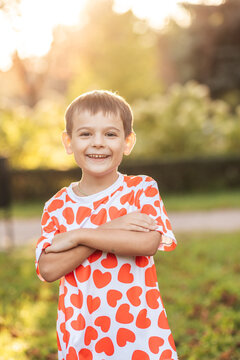 Children Enjoy Summer Fun Together With a Smiling Boy Wearing a Shirt With Heart Patterns While in a Green Park During the Day
