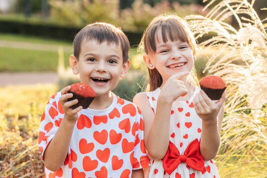 Children Enjoy Summer Holiday With Red Heart Cupcakes in a Park During Valentine's Day Celebration