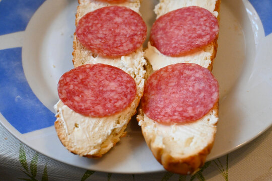 Salami bread rolls with creamy spread on a plate