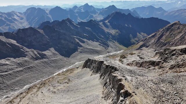 ⁠Epic aerial drone view over mountain ridge and deep valley in the Alps, cinematic landscape⁠
