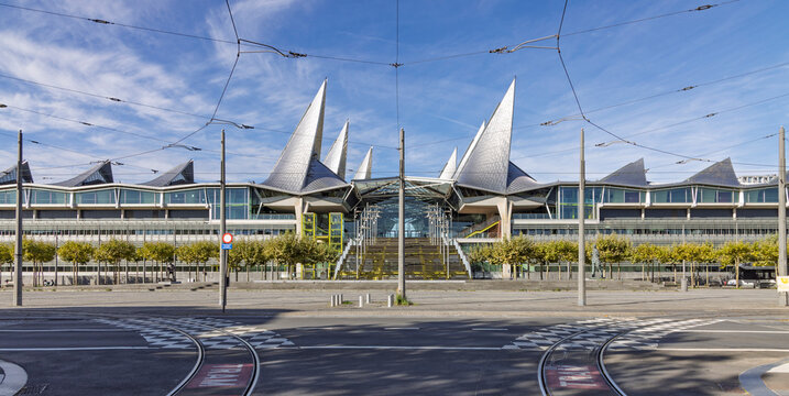 Antwerp, Belgium - September 06, 2026: Frontal view of the Vlinderpaleis (Palace of Justice) building featuring its iconic glass and steel roof structures and tram tracks.