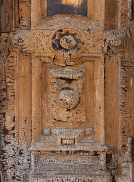 Weathered wooden door showing cracked peeling old paint texture