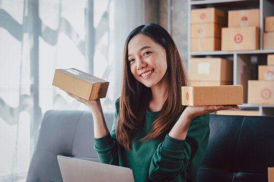 Asian Young Woman Small Business Owner with Shipping Box Parcel