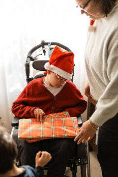 Child with cerebral palsy receiving christmas gift