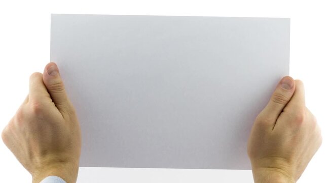 Close view of two hands holding a horizontal blank white paper sheet with slight movement, isolated on a white background for message, design, or presentation concepts