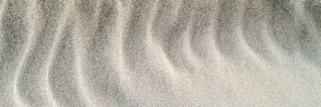 Sand texture with natural wave pattern, panoramic banner background.