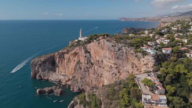 Cabo de la nao lighthouse sitting on a cliff in javea, spain