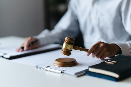 Justice lawyer considering a legal documents in courtroom